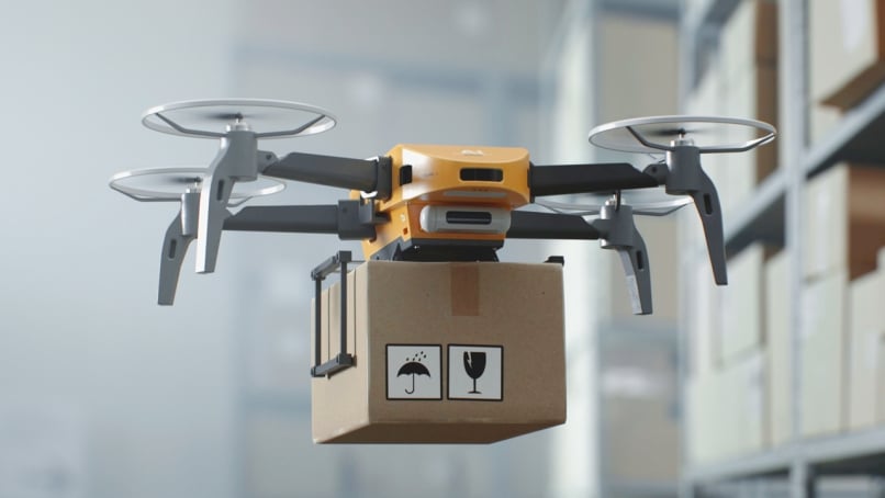 An unmanned aerial vehicle (UAV) delivers a cardboard box