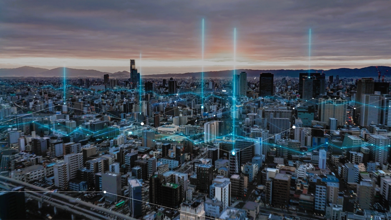 Smart City Connectivity Network Aerial view of city with connectivity network represented by glowing blue lines and dots.
